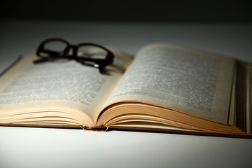 Vintage old books on wooden deck table and grunge background