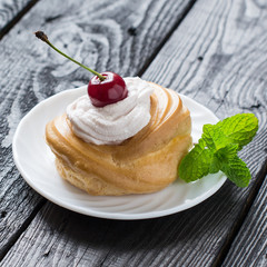 Cake with cream and cherry
