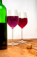 Wine glass and bottle on a wooden table