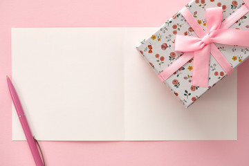 Greeting card, gift box and pen in pink colors