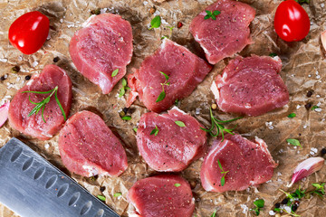 Raw pork tenderloin on crumpled paper. ready to cook.