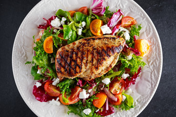 Grilled Chicken Breast fillet with fresh tomatoes vegetables salad. concept healthy food.