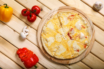 Pizza on light wooden background top view