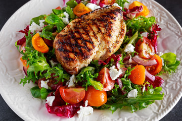 Grilled Chicken Breast fillet with fresh tomatoes vegetables salad. concept healthy food.