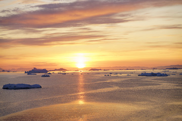 Sunset time on icebergs to ilulissat fjord at Greenland