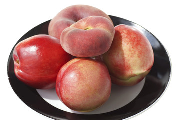 Fototapeta na wymiar Peaches and nectarines on the plate.