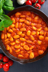 Homemade Italian Gnocchi with marinara sauce in iron pan