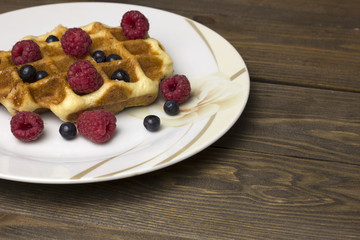waffles in a white plate with berries