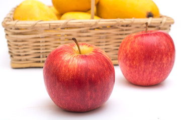 Mango in basket and apple on front
