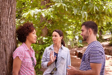 Two girls and a guy chatting