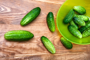 Mini cucumbers in bowl on table