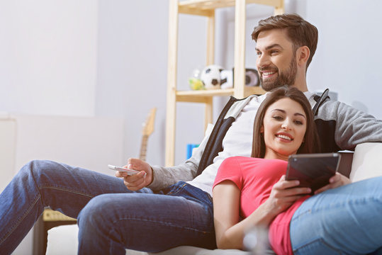 Man And Woman Watching Tv On Couch