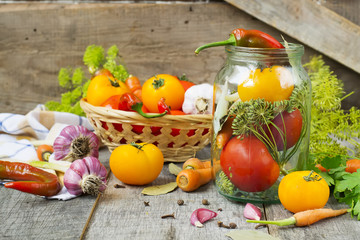 Tomatoes, herbs, garlic, glass jar - set for home canning.