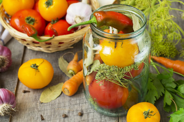 Tomatoes, herbs, garlic, glass jar - set for home canning.
