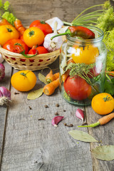 Obraz na płótnie Canvas Tomatoes, herbs, garlic, glass jar - set for home canning.