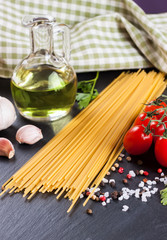 Pasta ingredients on black background.