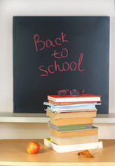 Pile of books in front school board