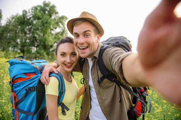 Joyful loving couple photographing on journey