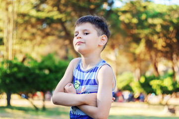 Portrait of a confident six year old boy in the park, 