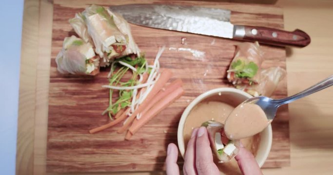 Woman Eating Food. Fresh Spring Rolls With Homemade Thai Peanut Sauce. Top Angle From Above. An Appetizing Healthy Vegetarian Meal.
