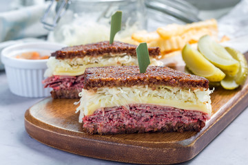 Classic reuben sandwich, served with dill pickle, potato chips, horizontal