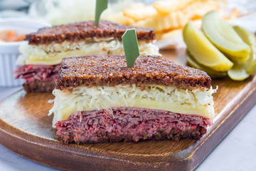 Classic reuben sandwich, served with dill pickle, potato chips, horizontal