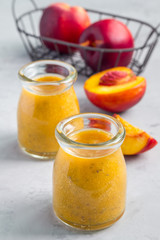 Smoothie with nectarine, orange juice, chia seeds and honey, vertical