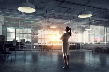 Businesswoman in modern office interior . Mixed media