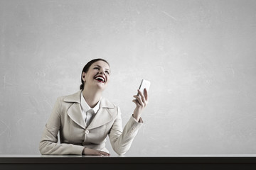 Attractive businesswoman having mobile conversation . Mixed media
