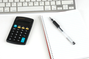 keyboard, calculator notebook and pen isolated on white background