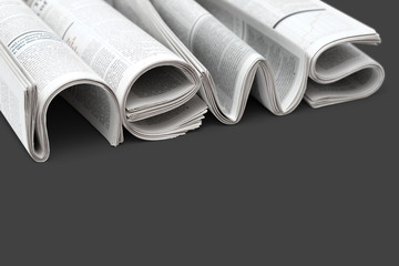 Folded modern newspapers. Concept of business news and print media