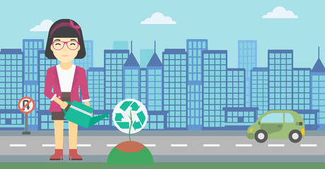 Woman watering tree with recycle sign.