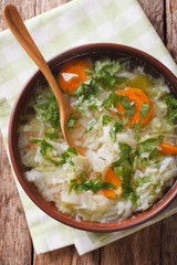 Diet vegetable soup close up in a bowl. vertical top view
