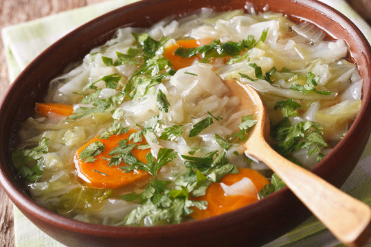 Diet soup with fresh cabbage close up in a bowl. horizontal

