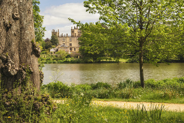 Fototapeta premium Landscape image of old Victorian house viewed across lake on Sum