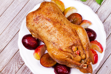 Roasted apple and plum stuffed duck. View from above, top studio shot