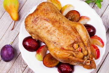 Roasted apple and plum stuffed duck. View from above, top studio shot