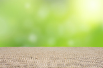 empty table with sack and blur green nature bokeh background can