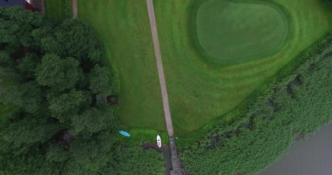 Cinema 4k aerial view on a flight above the lake, golf course and bodom mansion, in Espoo, Finland