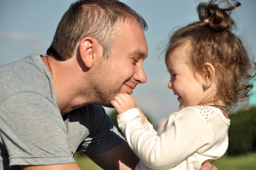 Fototapeta premium Happy father with his daughter outdoors hugging together