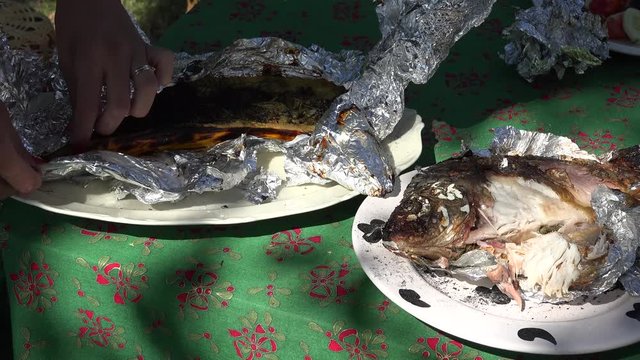 hand unwrap baked in foil zucchini vegetabale outdoor. 4K