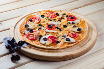 Italian pizza on the wooden background