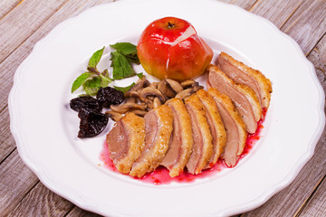 Duck breast with apple, smoked plums, mushrooms and basil in red wine sauce