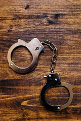 Police handcuffs on investigator detective's work desk