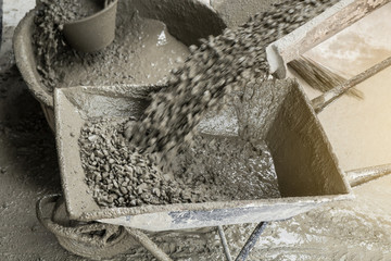 Motion Blur of Cement concrete pouring from cement truck into a cart mortar during for buildings...