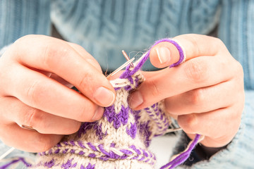 closeup hand knit wool sock on the needles