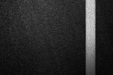 Level asphalted road with a dividing white stripes. The texture of the tarmac, top view.
