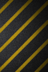 Fototapeta premium Level asphalted road with a dividing yellow stripes. The texture of the tarmac, top view.