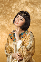 Conceived Beautiful woman like Egyptian Queen Cleopatra on golden background