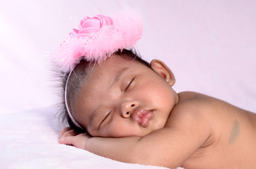 sleeping newborn baby on a blanket